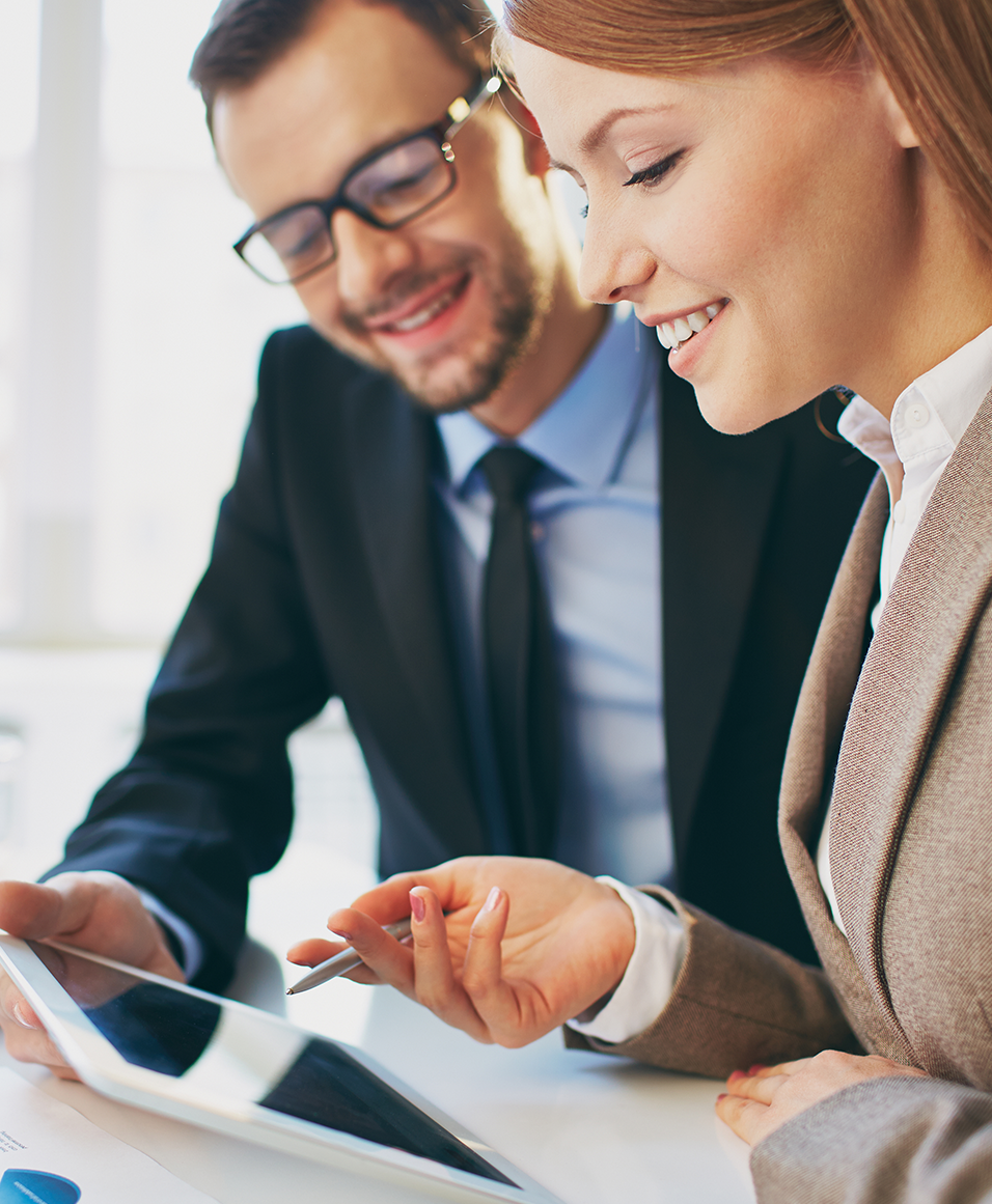 Business man and woman reviewing tax documents on tablet