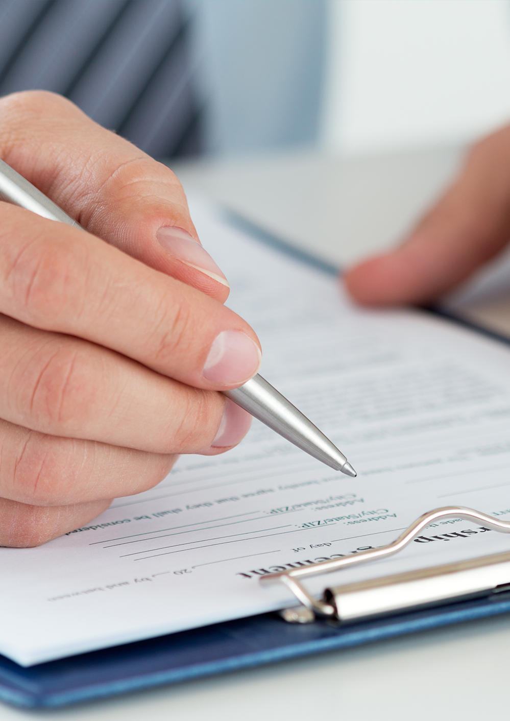 Close-up of accountant signing tax forms