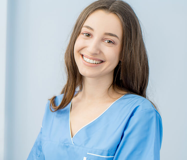 Smiling dental associate with long brown hair