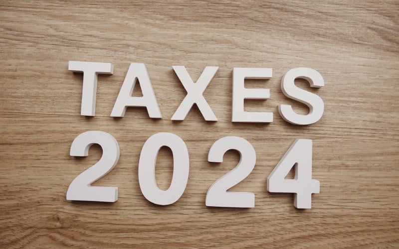 taxes 2024 alphabet letters wooden background