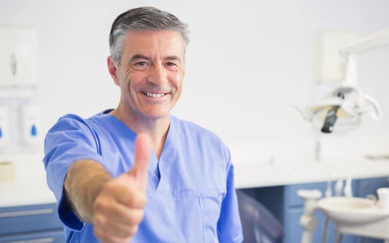 portrait of happy dentist-with thumbs up