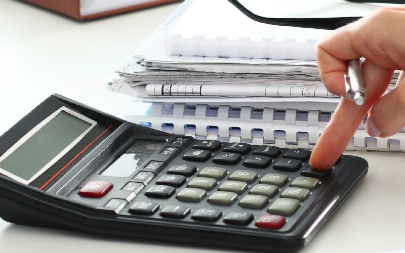 close up of female accountant or banker making calculations