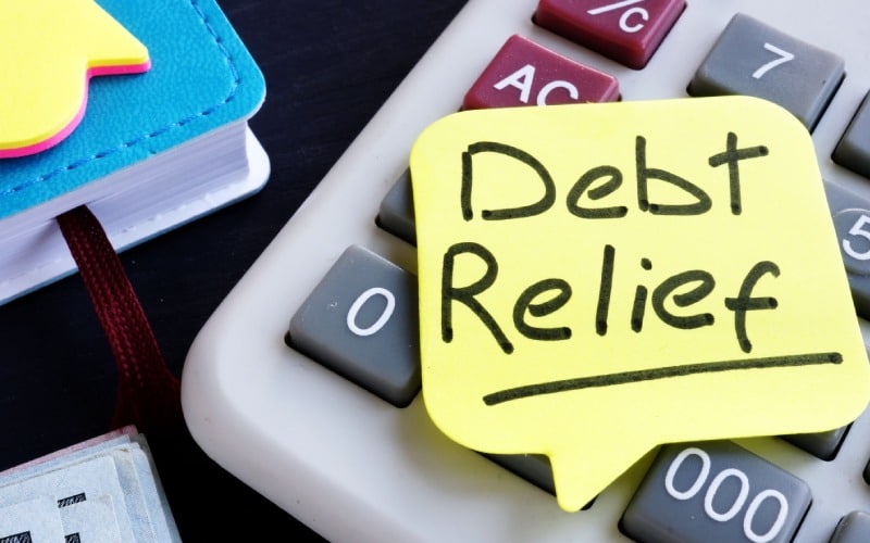 debt relief concept money calculator desk