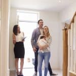 realtor showing family around property for sale