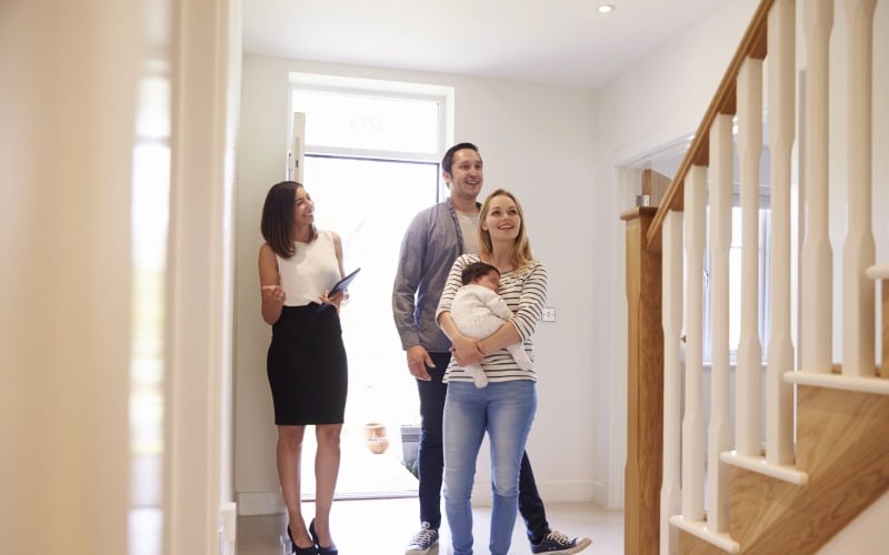 realtor showing family around property for sale