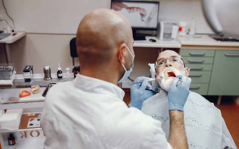 old man sitting dentist office