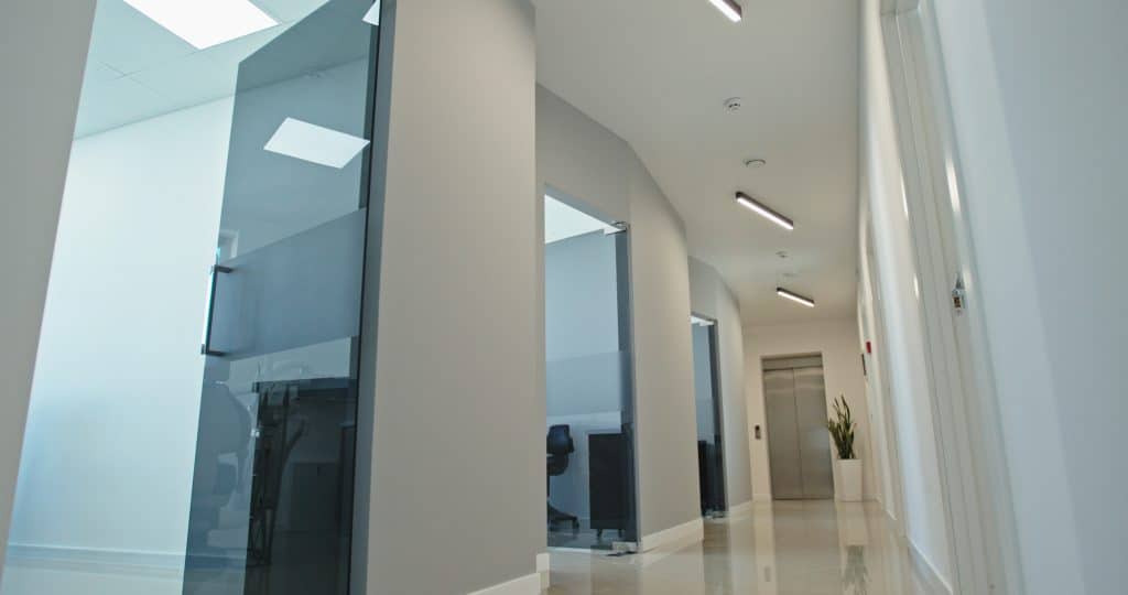 Modern dental clinic hallway with glass doors and clean design