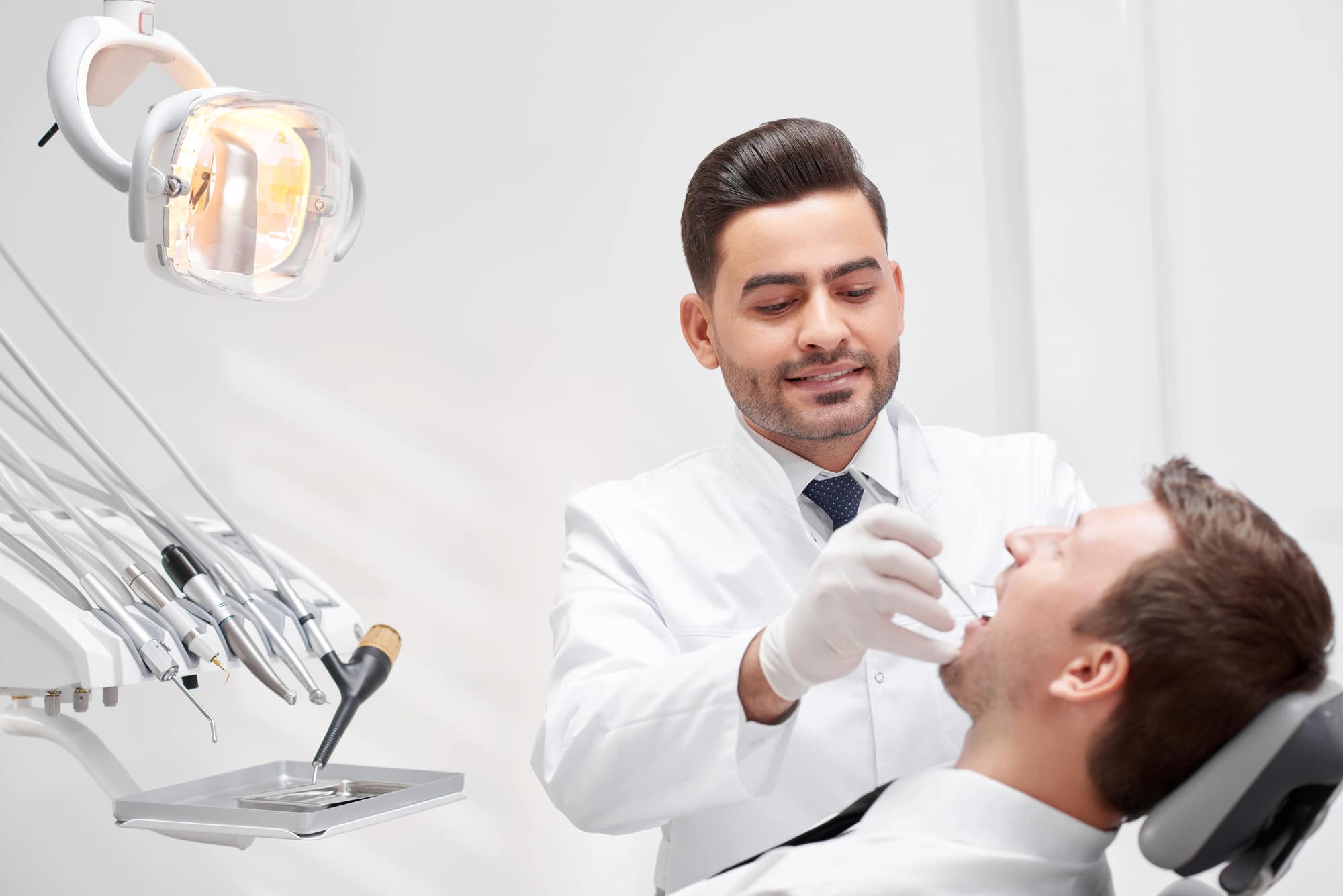 Professional dentist standing confidently in modern dental clinic
