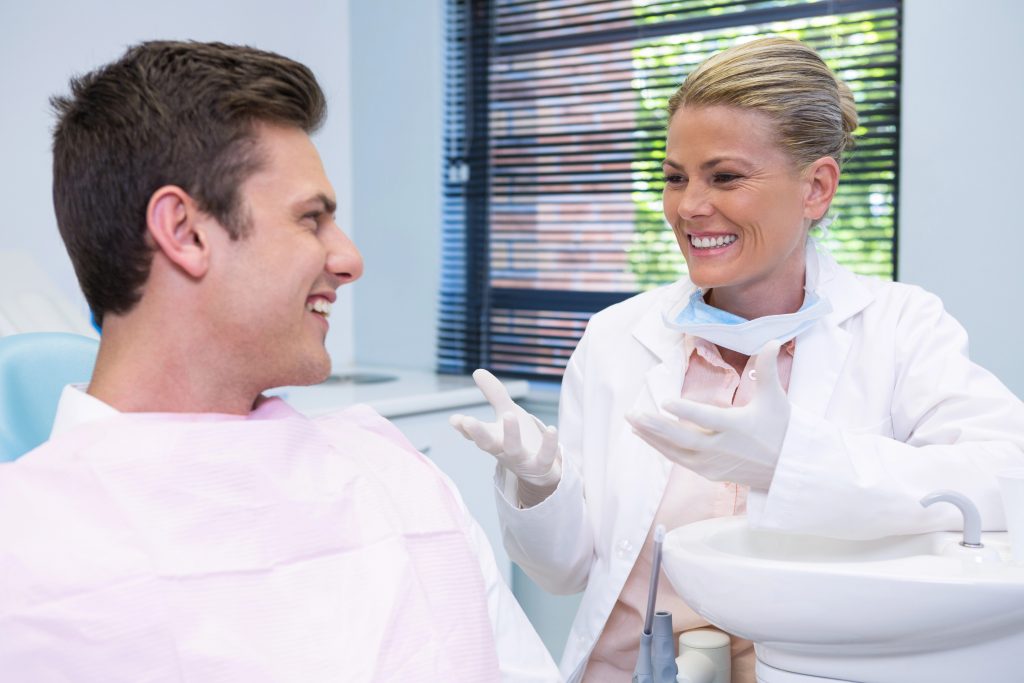 Dentist discussing dental treatment with a patient